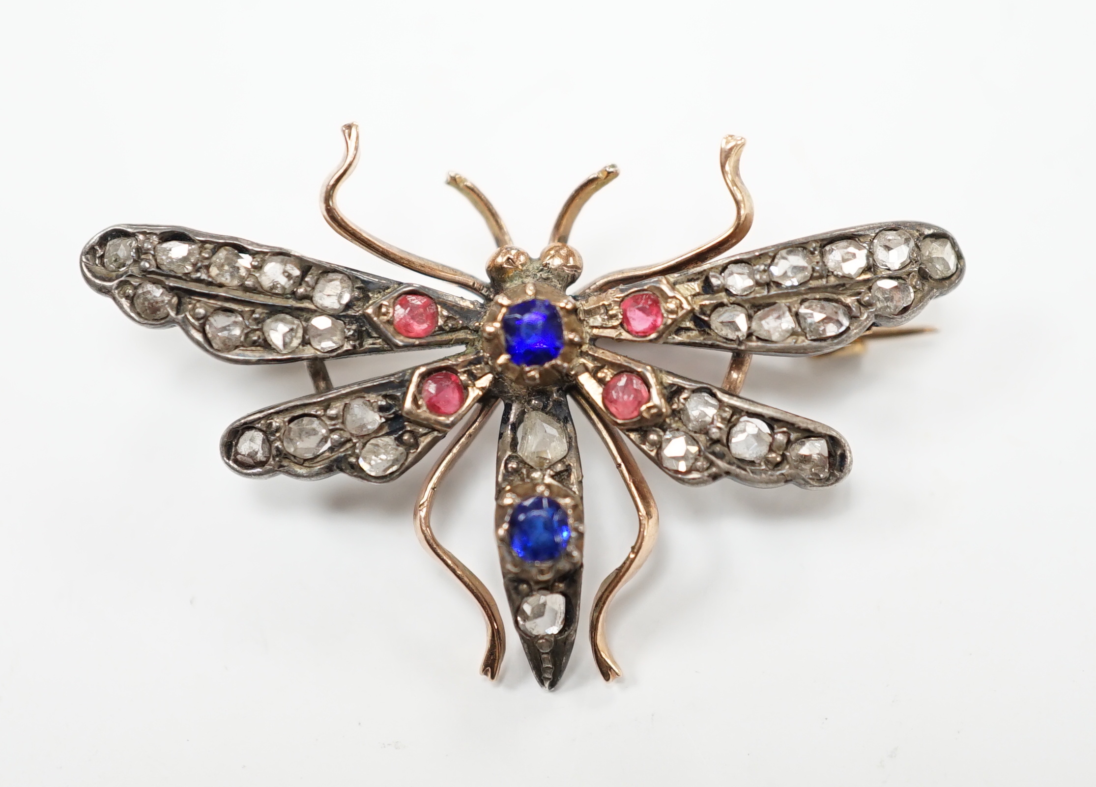 A Victorian yellow and white metal, rose cut diamond and two colour paste? set bug brooch, width 35mm, gross weight 4 grams.